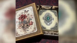 Vintage magic trick box with butterfly illustration and mysterious device inside.