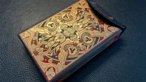 Luxurious Sacred Legends Black Edition playing cards with intricate gold and red design.