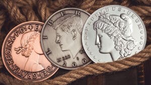 Large coin illusion featuring a jumbo Morgan silver dollar and copper penny.