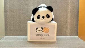 Cute plush toy morphing from panda to raccoon in a magic trick.