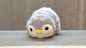 Soft plush toy transforming from panda to penguin in grey, by Jackie Zhao.