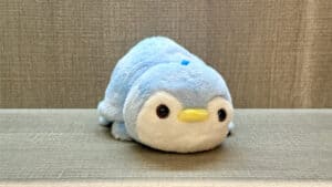 Soft plush toy transforming from a panda to a blue penguin, demonstrating a magical morphing illusio.