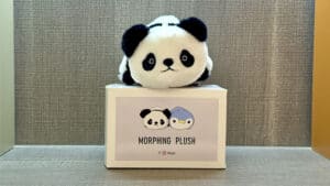 Plush toy transforming from panda to penguin in a magic trick demonstration.