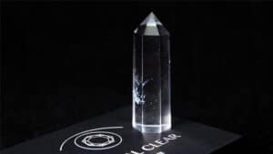 Crystal clear illusion with a tall, transparent prism on a black background.