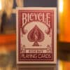 Bicycle Metallic Ruby playing cards with a spade design on the box.