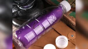 Colorful silk handkerchief inside a plastic bottle for magic trick.