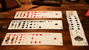 Close-up of a card trick setup with multiple playing cards on a wooden table.