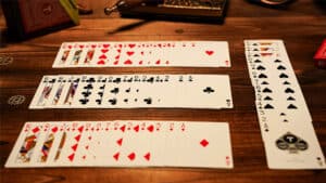 Close-up of a card trick setup with multiple playing cards on a wooden table.