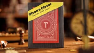 Close-up of Olson's Closer card magic trick by Erick Olson on a wooden table.