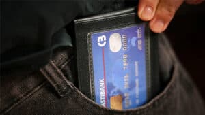 Close-up of a leather Phantom Wallet holding a credit card for magic tricks.