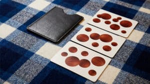 Close-up of perception experiment cards with wooden patterns on a checkered cloth.