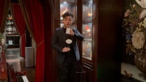 Magician performing a rose illusion in a luxurious setting for magical entertainment.