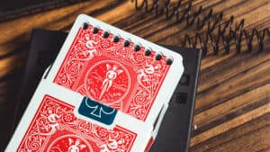 Elegant close-up of The Bound Deck, a magic trick deck by Juan Luis Rubiales, on a wooden surface.