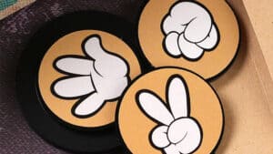 Hand gesture magic trick prediction game with three cards showing different hand signs.