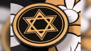 Close-up of a magic prediction coin with a Star of David symbol for magic tricks.