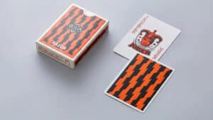 Quality Razor playing cards with bold orange and black zigzag design for magic tricks and cardistry.