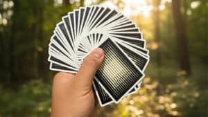 Refraction playing cards fanned in hand for magic tricks and card illusions.
