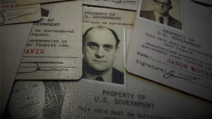 U.S. government property card with a man's photo and signature.