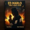 Ed Marlo book cover featuring a silhouette of a magician with playing cards and a smoking gun.