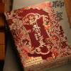 Intricate Chinese magic trick box with red and gold designs, perfect for illusion performances.