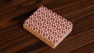 Close-up of Red Roots Pine Edition playing card on wooden surface.