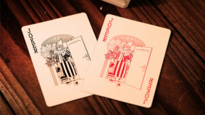 Close-up of Joker playing cards with red and black designs on a wooden surface.