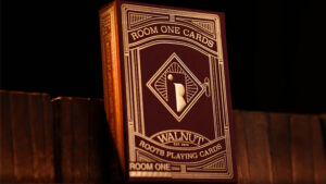 Room One Walnut Roots playing cards box with intricate design on black background.
