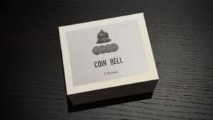 Coin Bell magic trick with coins and a small bell for illusion.