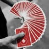 Close-up of Cyril playing cards fanned out in a magician's hand.