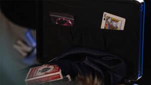 An image of a magic trick setup with playing cards and props for illusion performances.