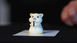 Small white hamster figurine performing a magic trick with a magic wand.