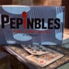 Close-up of Pepinbles thimble magic tricks with playing cards on a vintage table.
