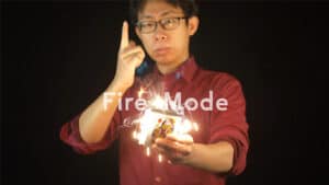 Man demonstrating thumb tip magic trick with glowing effects for illusion.