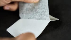 Up of a person handling a blank Svengali deck for magic tricks.