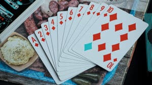 Retro black playing cards with red and blue diamond suits, displayed in a fan shape.