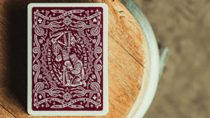 Elegant royal purple playing card with intricate design for magic tricks.