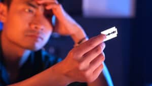 Close-up of magician performing card trick from Nightmare by Liang Kuai & Amor Magic.