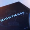 Close-up of "Nightmare" magic trick book by Liang Kuai & Amor Magic on a dark surface.