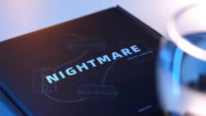 Close-up of "Nightmare" magic trick book by Liang Kuai & Amor Magic on a dark surface.