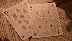 Quality Assassin's Creed Legacy Version 2 Garnet playing cards featuring a black hidden blade motif.