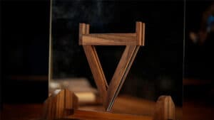 Mirror illusion performing a stunning magic trick with a wooden mirror prop.