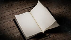 Open Harry Potter-themed self-coloring book with blank pages on wooden surface.