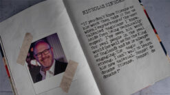 Close-up of a vintage book page with a photo of Etienne Pradier and handwritten notes about magic tr.