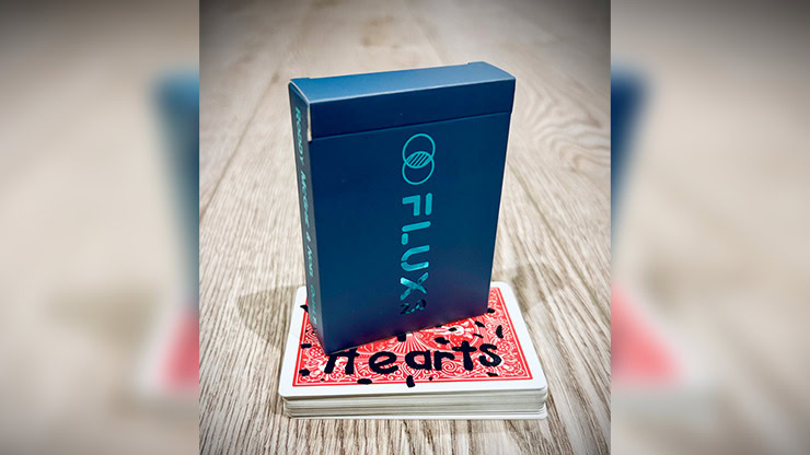 Flux 2.0 magic trick box with playing cards on a wooden surface.