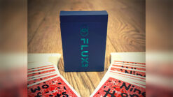 Flux 2.0 magic trick box with playing cards on a wooden surface.