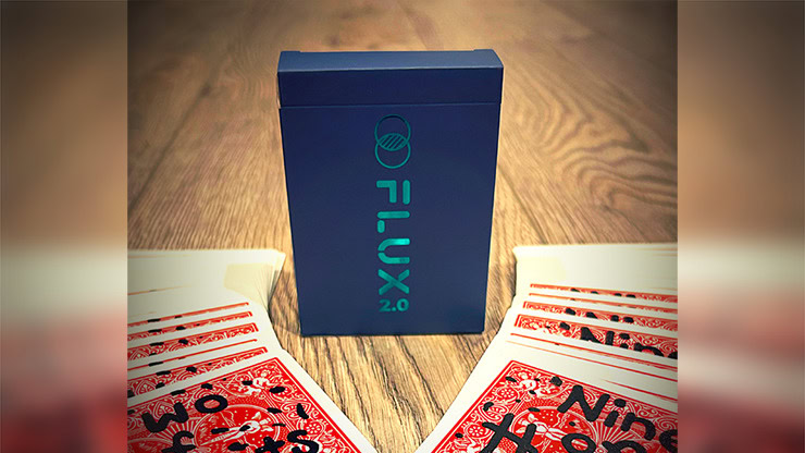 Flux 2.0 magic trick box with playing cards on a wooden surface.