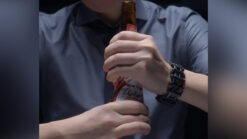 Person performing tornado bottle magic trick with a bottle in hand.