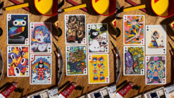 Colorful Bicycle Sari Sari themed playing cards spread out on a wooden surface.