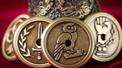 Close-up of noble virtues coins featuring symbols of justice, wisdom, and courage.