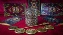 Close-up of coins, wand, and tarot cards for a magical illusion performance.